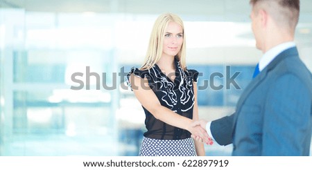 Business people shaking hands after meeting in office