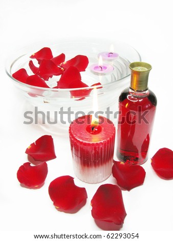 spa candles aroma oil essence among red rose petals