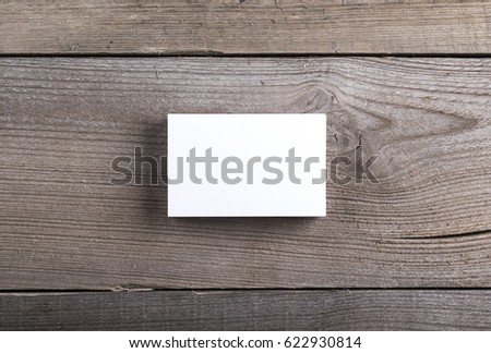 Photo of business cards. Template isolated on old wood background. For graphic designers presentations and portfolios damaged weathered antique mock-up with business cards.