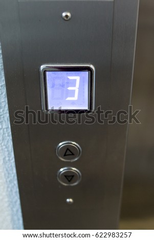 Close-up Elevator Pressing. Modern Metal Elevator. 3 floor.  Vertical photo