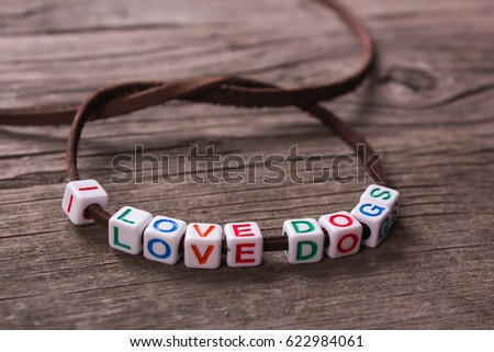 I love dogs. Cubes with letters on the bands. On a wooden table