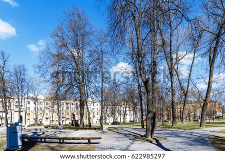 Green park in the center of the city in the early spring in sunny weather