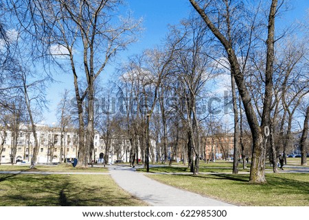 Green park in the center of the city in the early spring in sunny weather