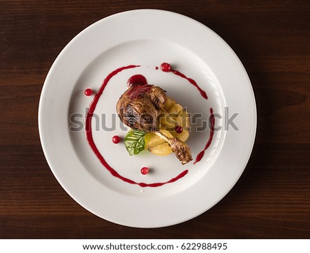Duck's leg with apples and cranberry sauce.European cuisine