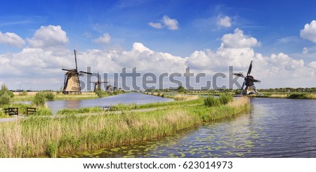 Traditional Dutch windmills on a bright and sunny day at the Kinderdijk in The Netherlands.
