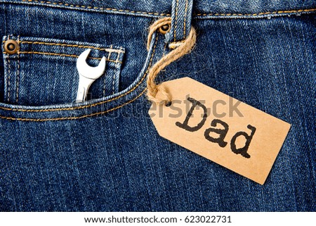 Dad tag with shifter tool on blue denim
