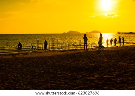 silhouette people on the beach with beautiful sunrise