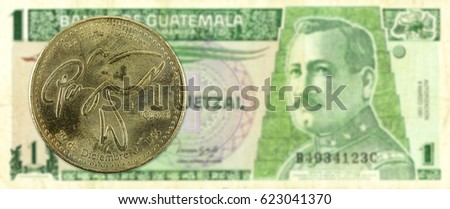 1 quetzal coin against 1 guatemalan quetzal bank note obverse