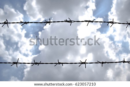 Barbed Wire fence, blue sky with clouds background.