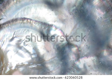 Abstract pearl background with lustrous nacre mother of pearl cloud blur with prism colours Royalty-Free Stock Photo #623060528