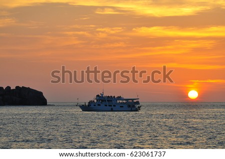 Small cruise ship travel in the ocean with sunset 