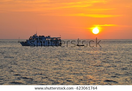 Small cruise ship travel in the ocean with sunset 