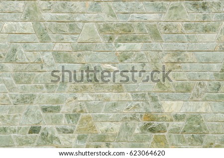 pattern color of modern style  design decorative  green slate stone wall surface with cement in trapezoid shape