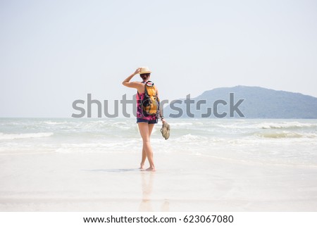 Young girl in hat on seashore