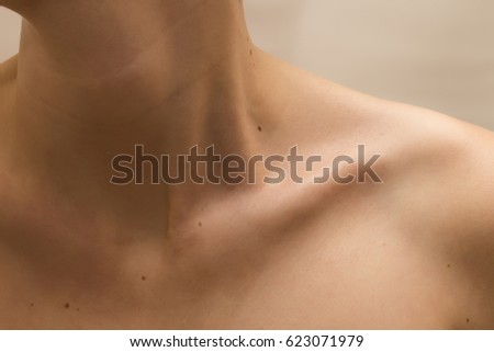 Female clavicles and neck with moles on the skin Royalty-Free Stock Photo #623071979