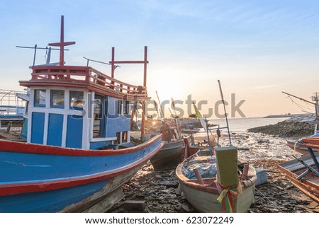 Fishing boat with sunset light on the beach 