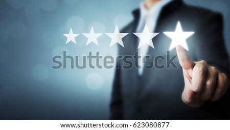 Businessman pointing five star symbol to increase rating of company Royalty-Free Stock Photo #623080877