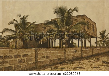 Creative vintage. Palm trees on a background of unfinished building. Abandoned house. Retro. Old photo on paper background for your text