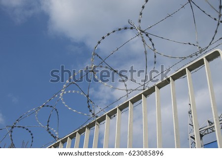 Barbed wire on the fence. Protective fencing specially protected object of barbed wire. Stamped barbed wire.