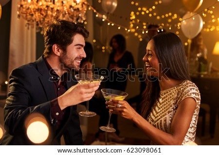 Couple Make Toast As They Celebrate At Party Together