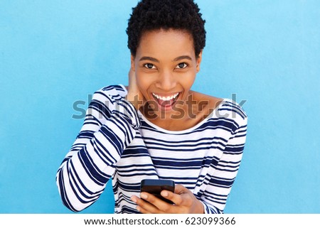 Portrait of smiling african woman holding smart phone 
