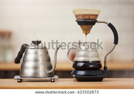 Close up of coffee brewing gadgets on wooden bar counter. Royalty-Free Stock Photo #623102873