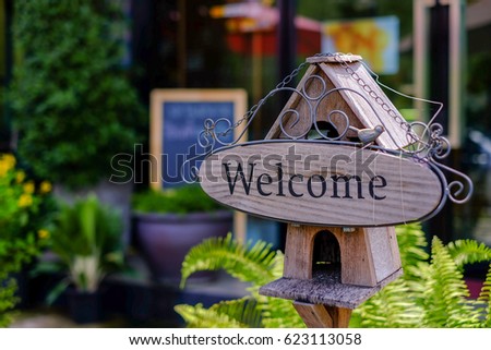 welcome sing on the little house in front of coffe shop