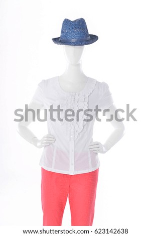 female in white dress with blue hat on mannequin