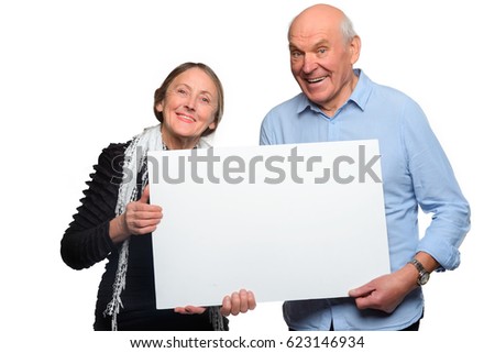 Cheerful old-aged couple hold a placard. A huge white space for your content. Horizontal studio shot on a white background.
