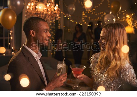 Couple Chat As They Enjoy Cocktail Party Together