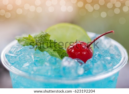 Close up blue hawaii Italian soda with cherry and mint.
