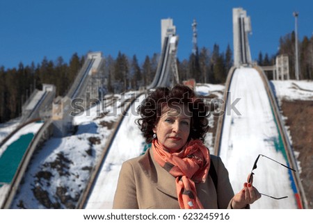 Woman on a background ski-jump complex "Stork". Mount Dolgaya. Nizhny Tagil. Sverdlovsk region. Russia.