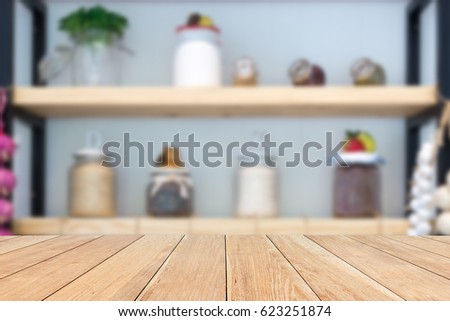 Natural empty pattern wooden table with blurred kitchen, various food ingredients and utensils. interior background - can be used for display or montage your products.