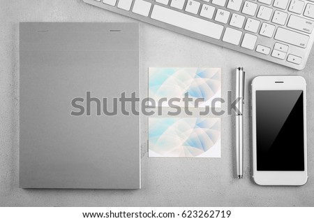 Stationery with business cards, computer and smart-phone on light table