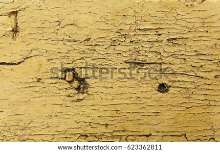 Old peeling beauty on a wooden surface. Colors dry pattern stretch. Grunge wall. Abstract raw old paint dirty wall background. Vintage background.