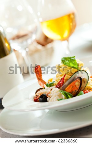 Seafood Spaghetti with Tiger Prawns, Scallops, Mussels, Calamari, Salmon and Tomato Sauce Royalty-Free Stock Photo #62336860