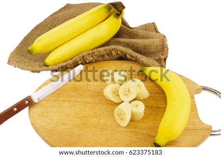 sliced peeled banana, knife, chopping wood and sack isolated on white background.