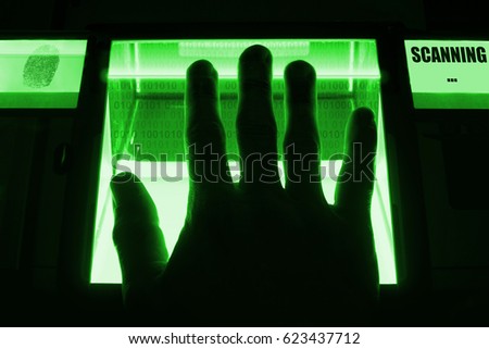 A person uses a fingerprint scanner. Can be used for biometrics or cybersecurity concepts.