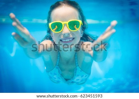 Underwater portrait of child. Kid having fun in swimming pool. Summer vacation concept