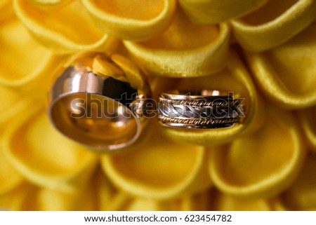 diamond ring on yellow flower. wedding rings together. selective focus