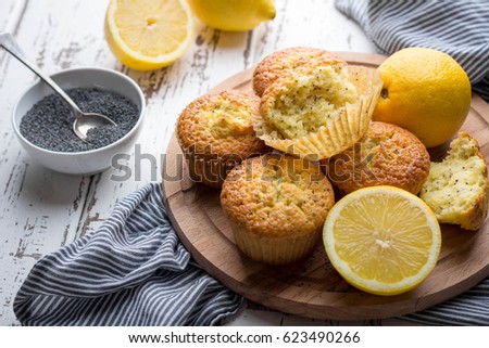 Homemade lemon poppy seed muffins on light rustic background