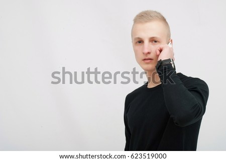 Young man talking on his mobile phone isolated on white background