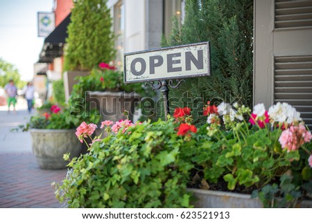 Farmhouse style open sign outside of a small town Business  