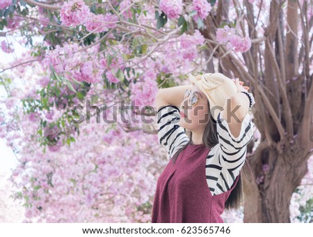 Women Asia tourist hat See pink trumpet tree and sky