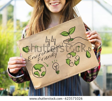 Farmer woman holding go green banner Royalty-Free Stock Photo #623571026