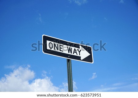 one way sign in front of blue sky and white cloud
