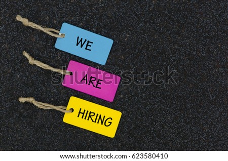 we are hiring written on colorful wooden tag