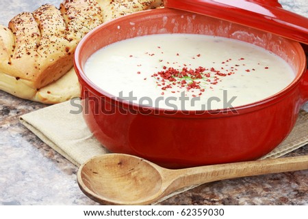 Homemade potato soup garnished with vegetarian bacon bits and chives and served with Italian herb bread.