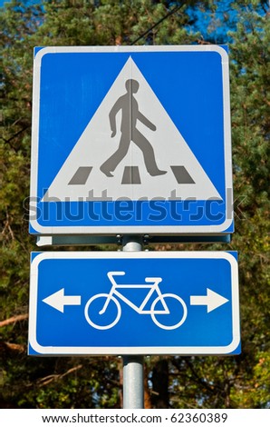 Road sign warns about pedestrian crossing and bicycle road
