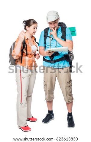 Couple of tourists arguing and looking for a path on a map on a white background in the studio